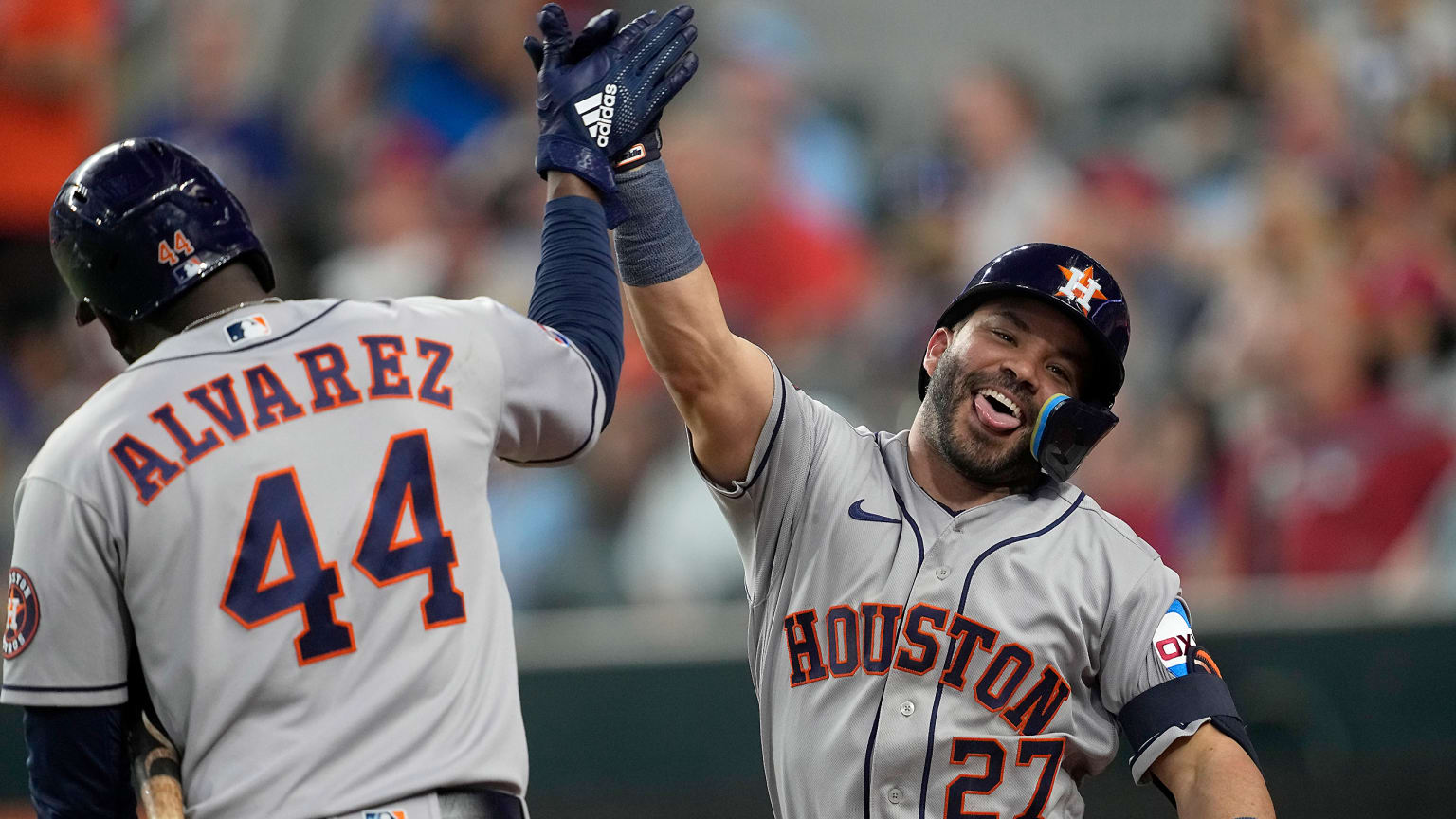 Yordan Alvarez high-fives Jose Altuve