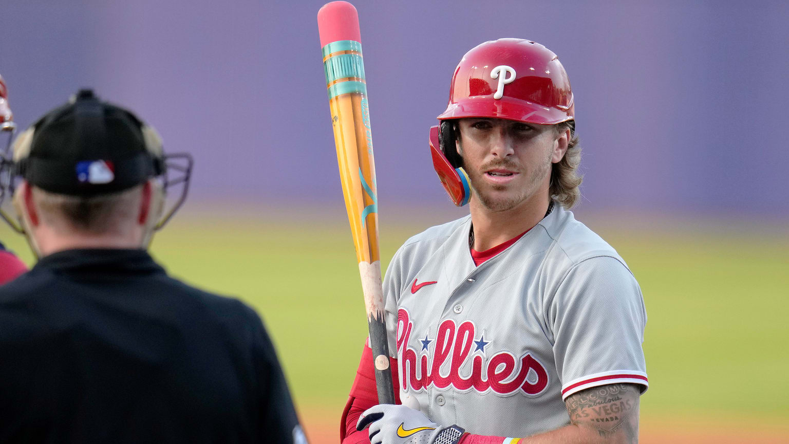 Bryson Stott holds a bat painted to look like a pencil