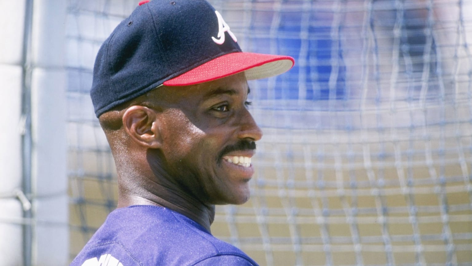 A smiling Fred McGriff stands near the batting cage