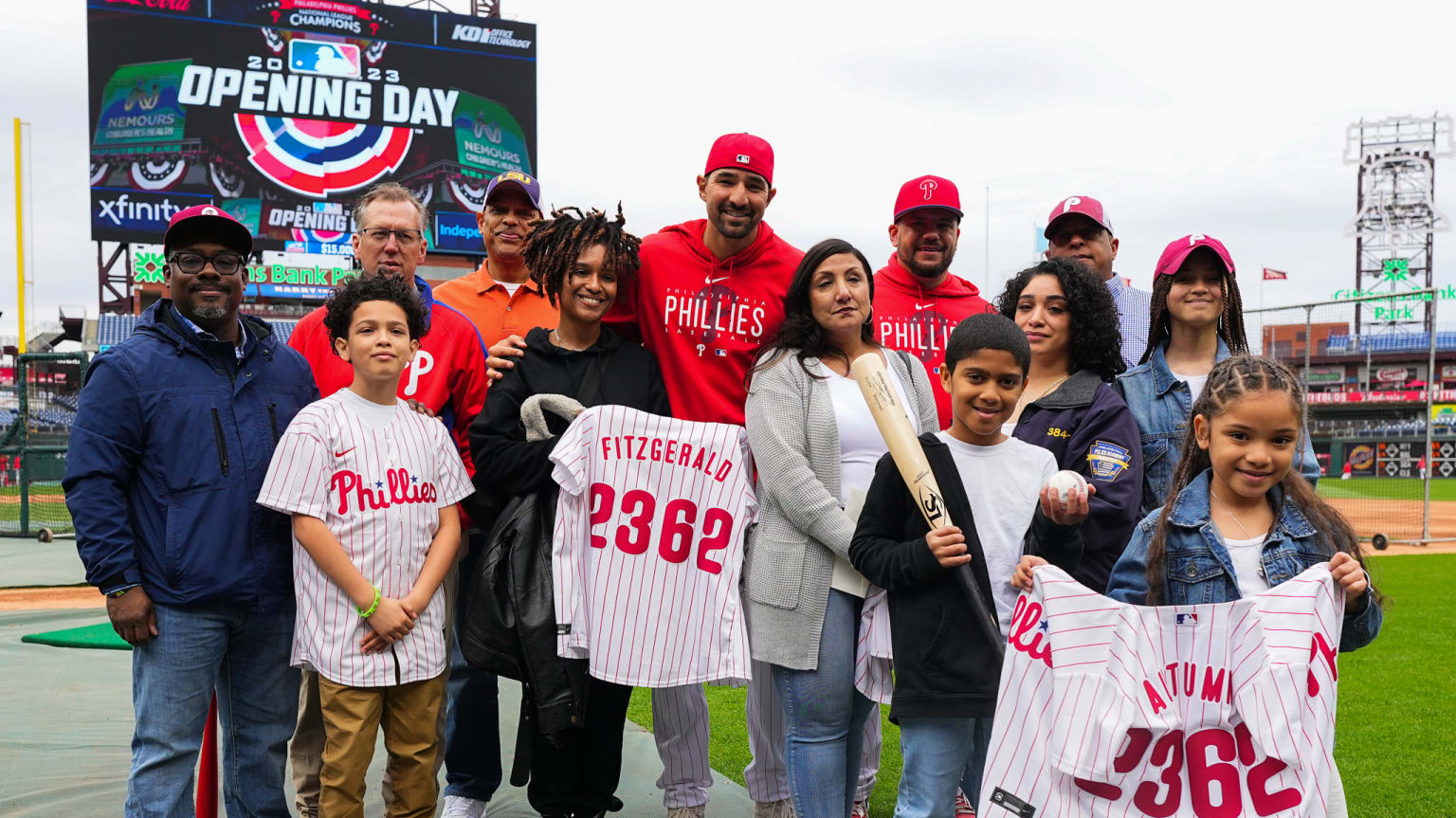 Nick Castellanos and Kyle Schwarber of Phillies pose with family of fallen Temple University police officer Christopher Fitzgerald