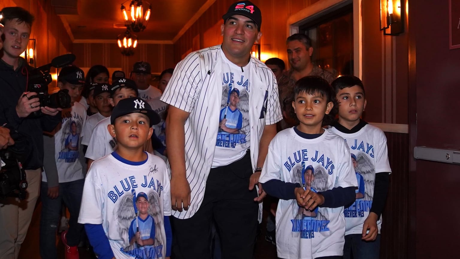 Jose Trevino walking with three young kids