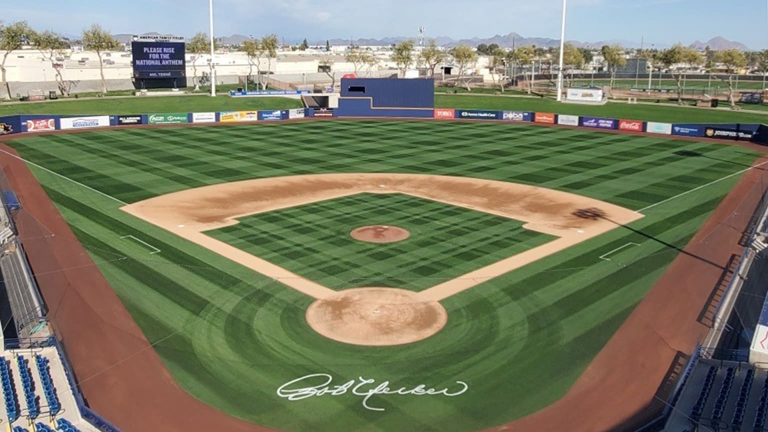 Bob Uecker's signature is displayed on the field behind home plate