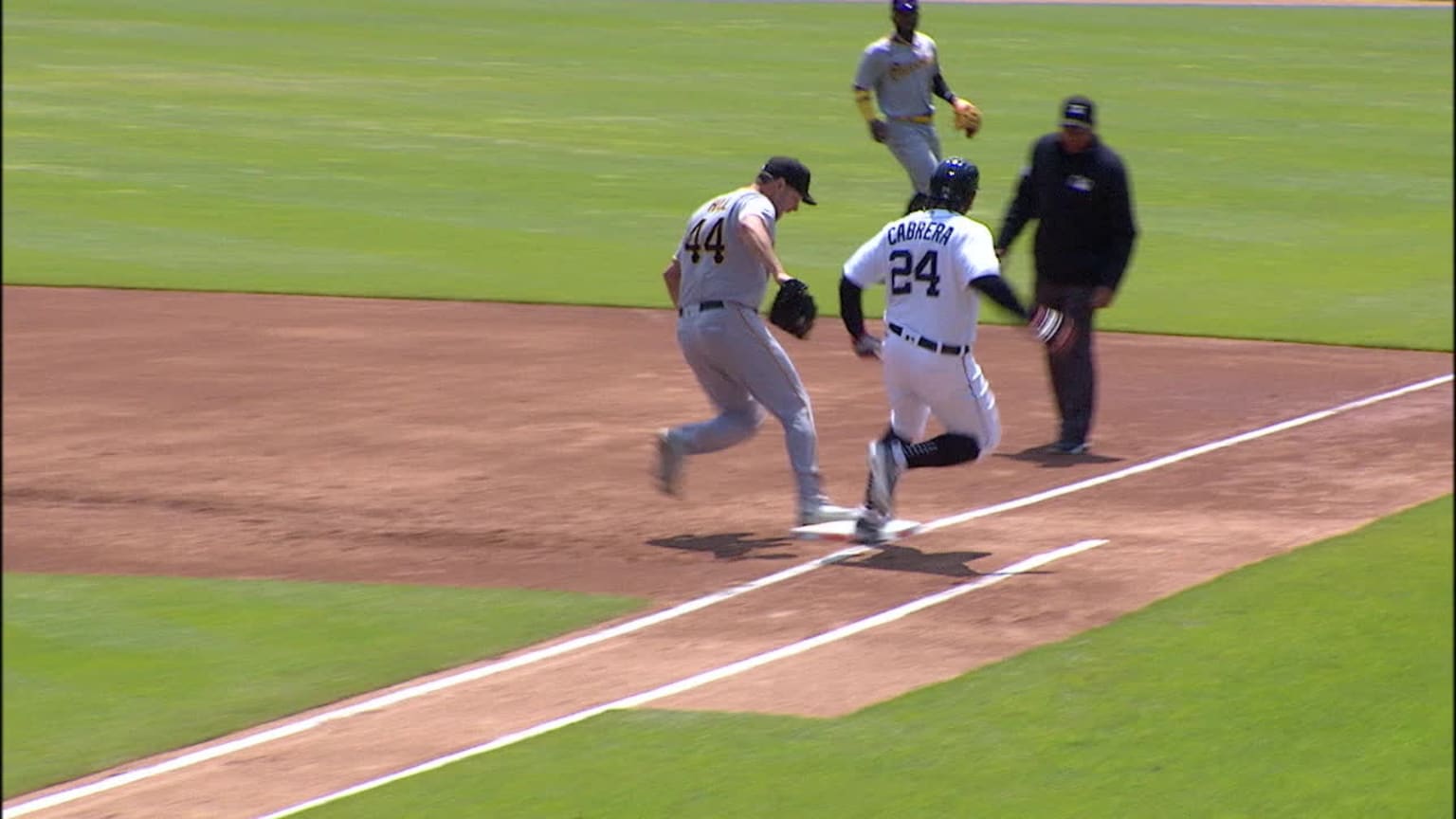 Rich Hill and Miguel Cabrera touch first base in a close play