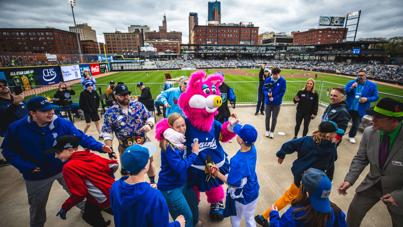 A Minor League mascot hugs fans