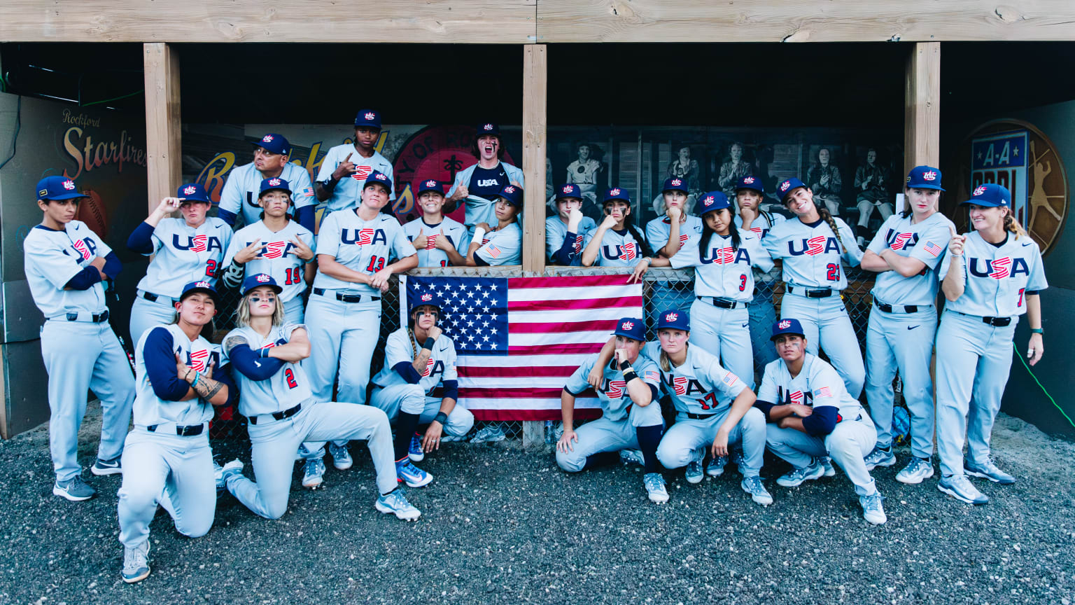 The women of Team USA pose for a team photo with an American flag