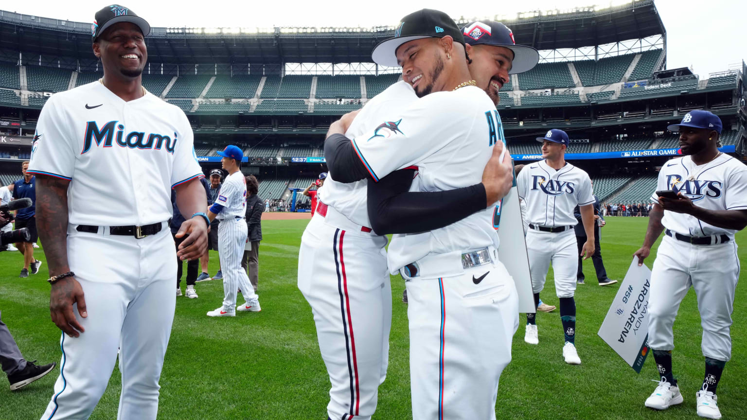 Pablo Lopez and Luis Arraez embrace on the field