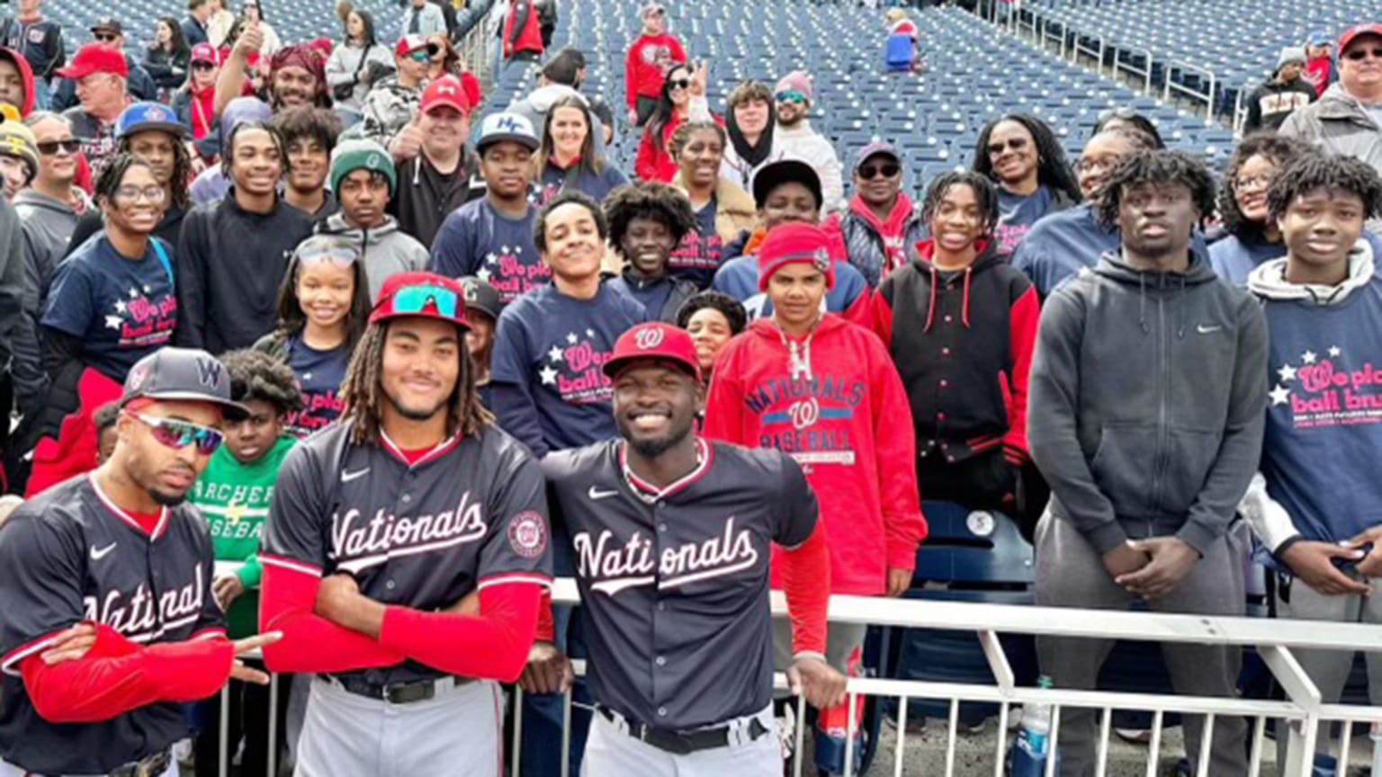 Nasim Nuñez and James Wood pose for a picture with kids