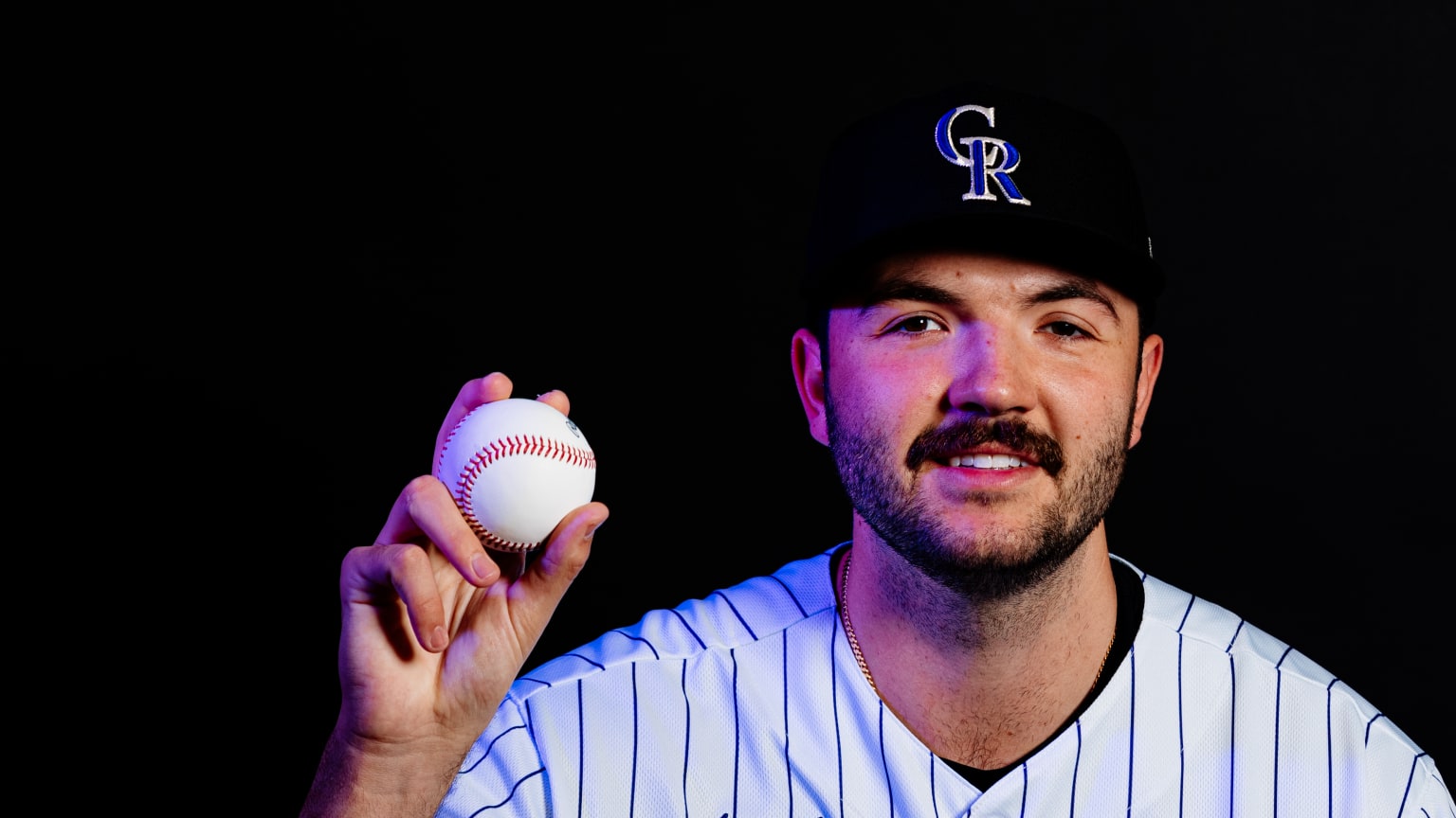 Riley Pint poses for a photo while holding a baseball