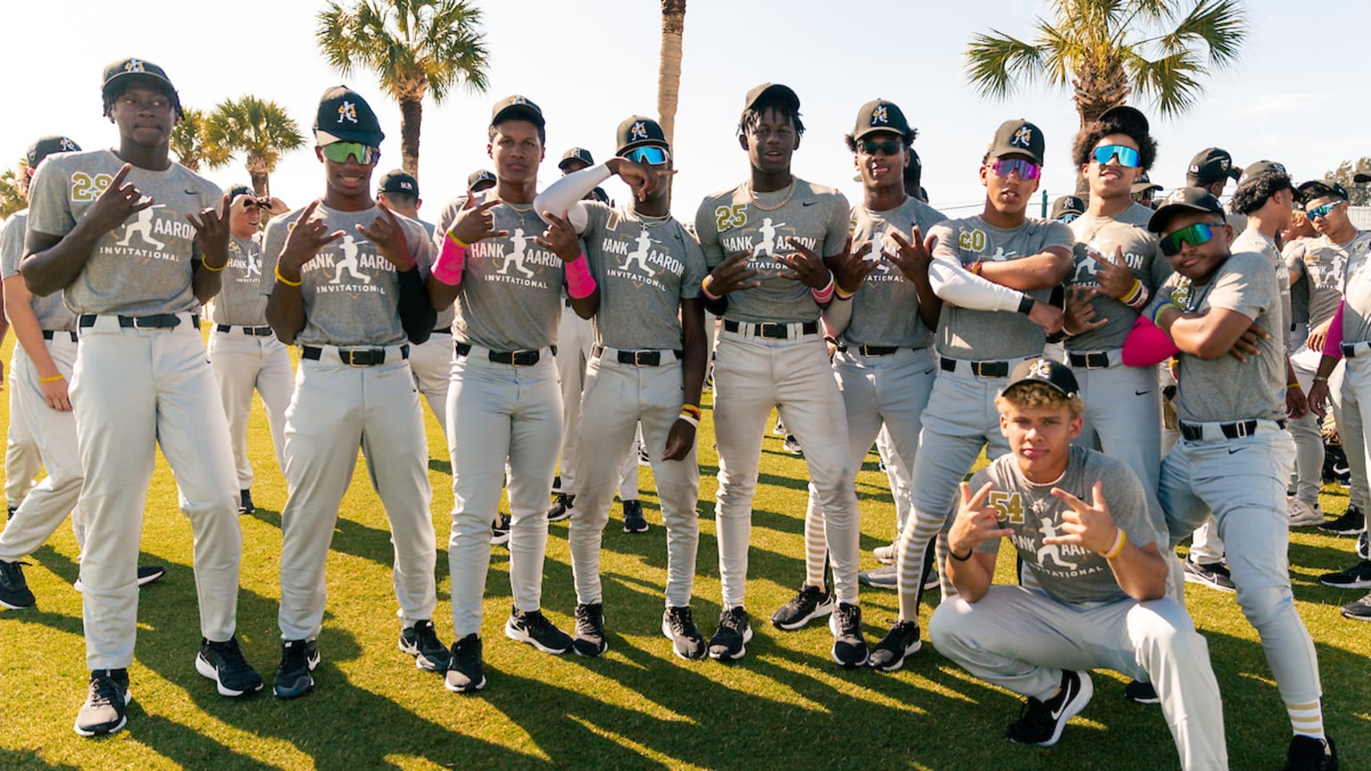 Several young players pose and flex for the camera