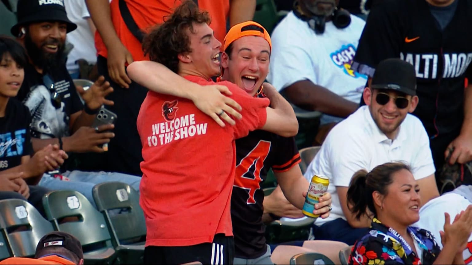 Two Orioles fans hug it out in the bleacher seats