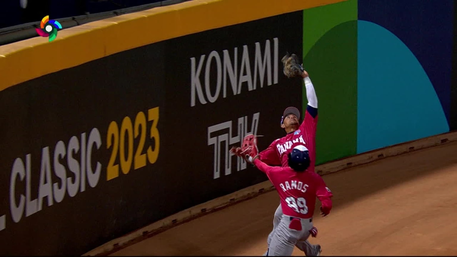 Two outfielders about to collide near the wall