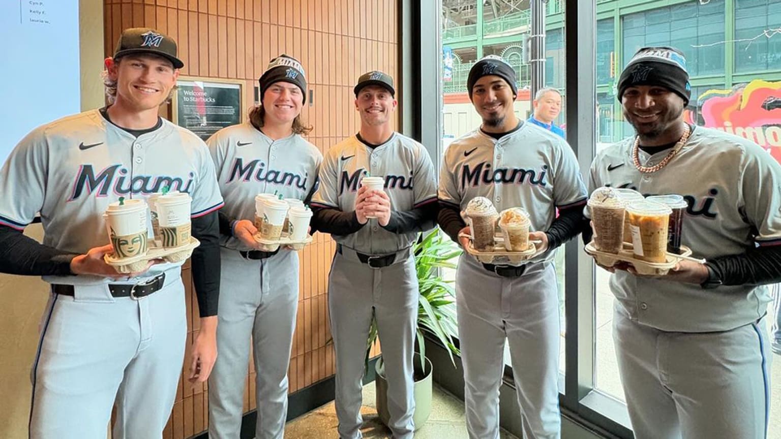 Five Marlins players with coffee in a coffee shop
