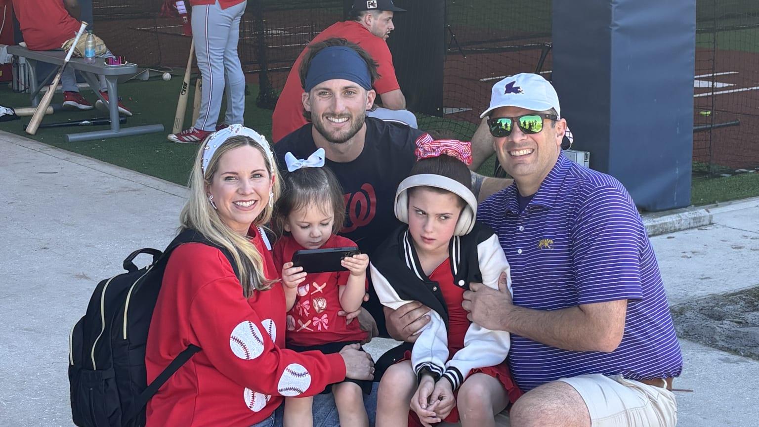 Dylan Crews huddles with the White family at Spring Training