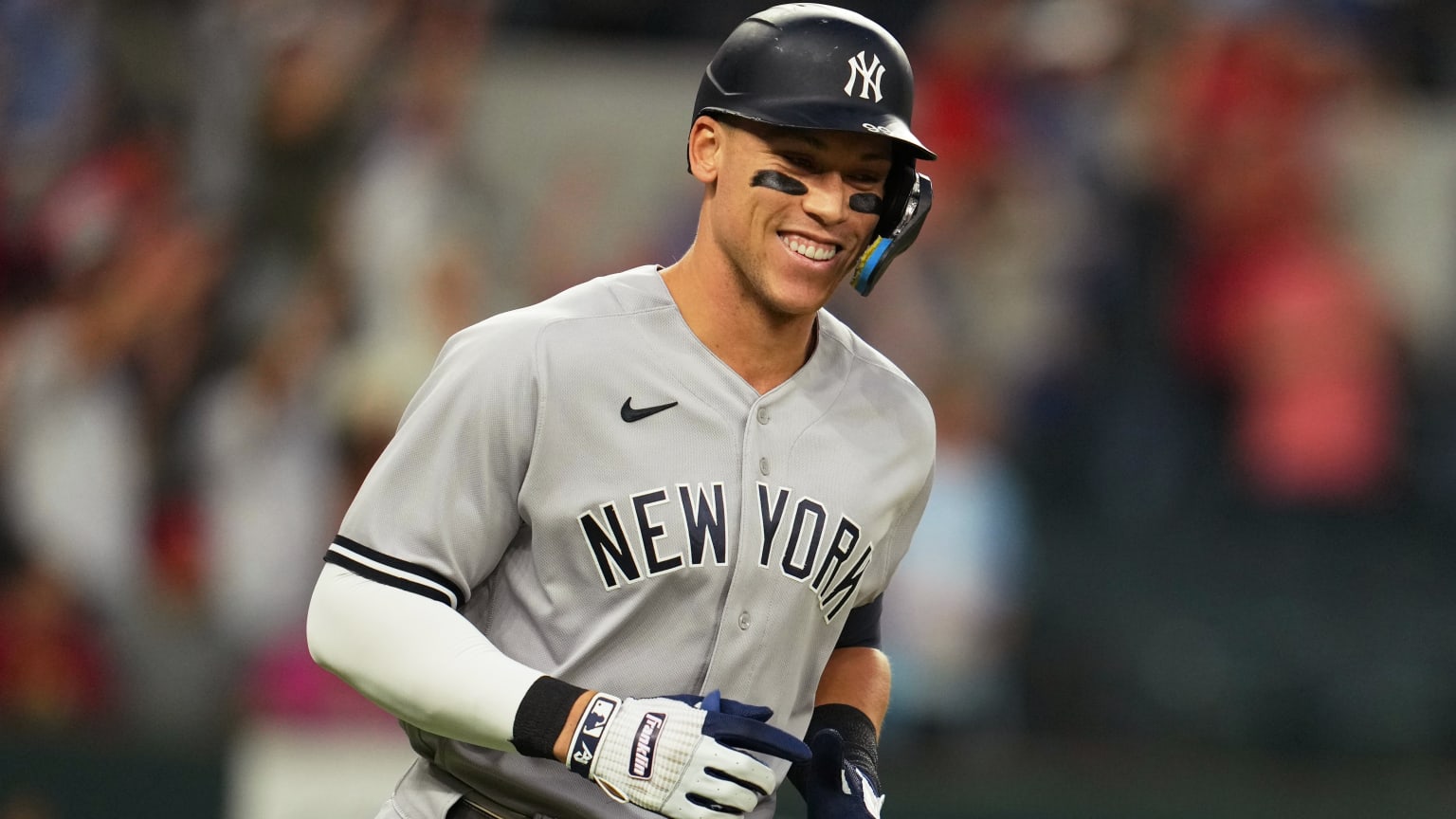 Aaron Judge smiles while running the bases