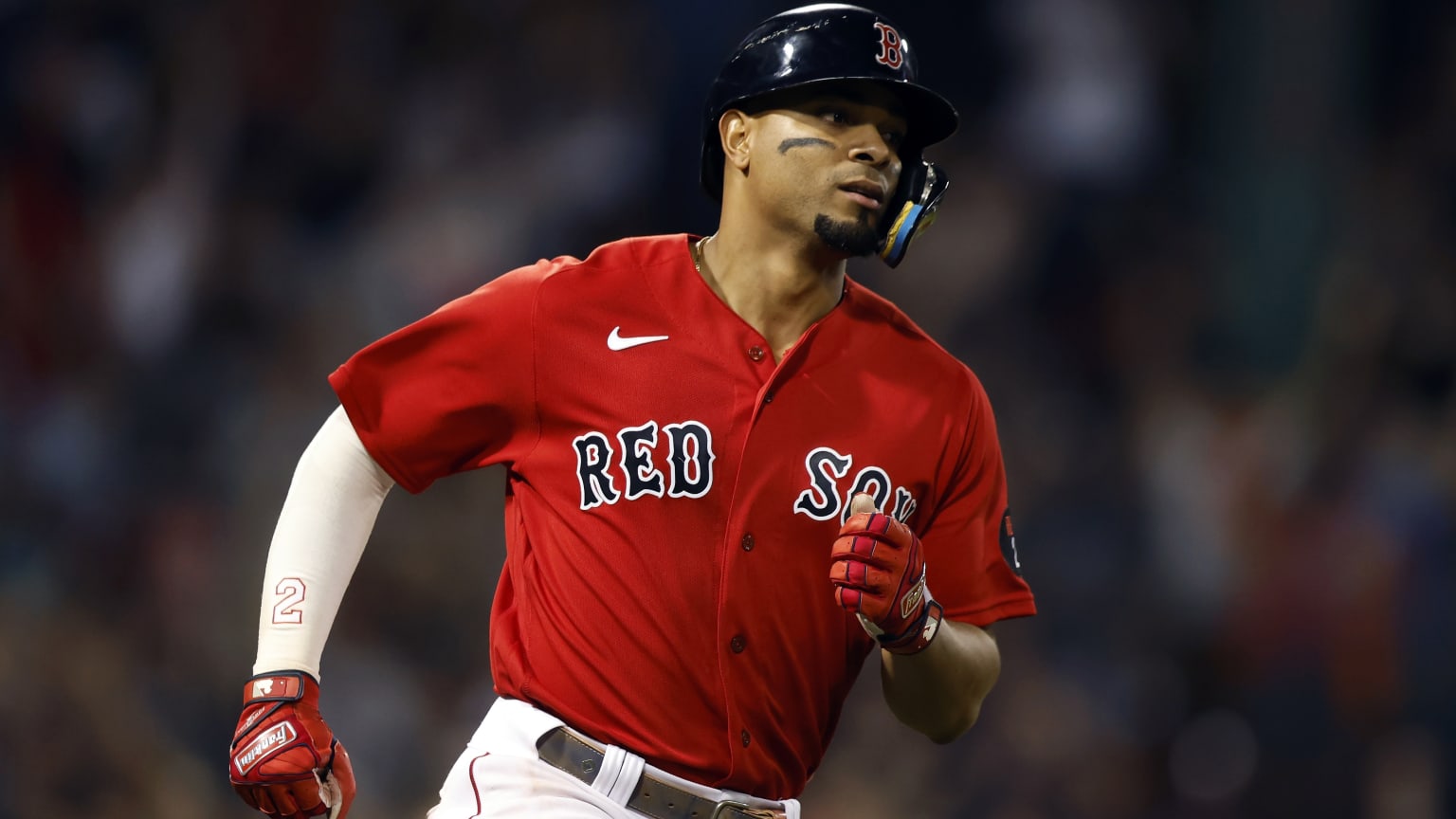 Xander Bogaerts runs the bases in a red Boston Red Sox jersey