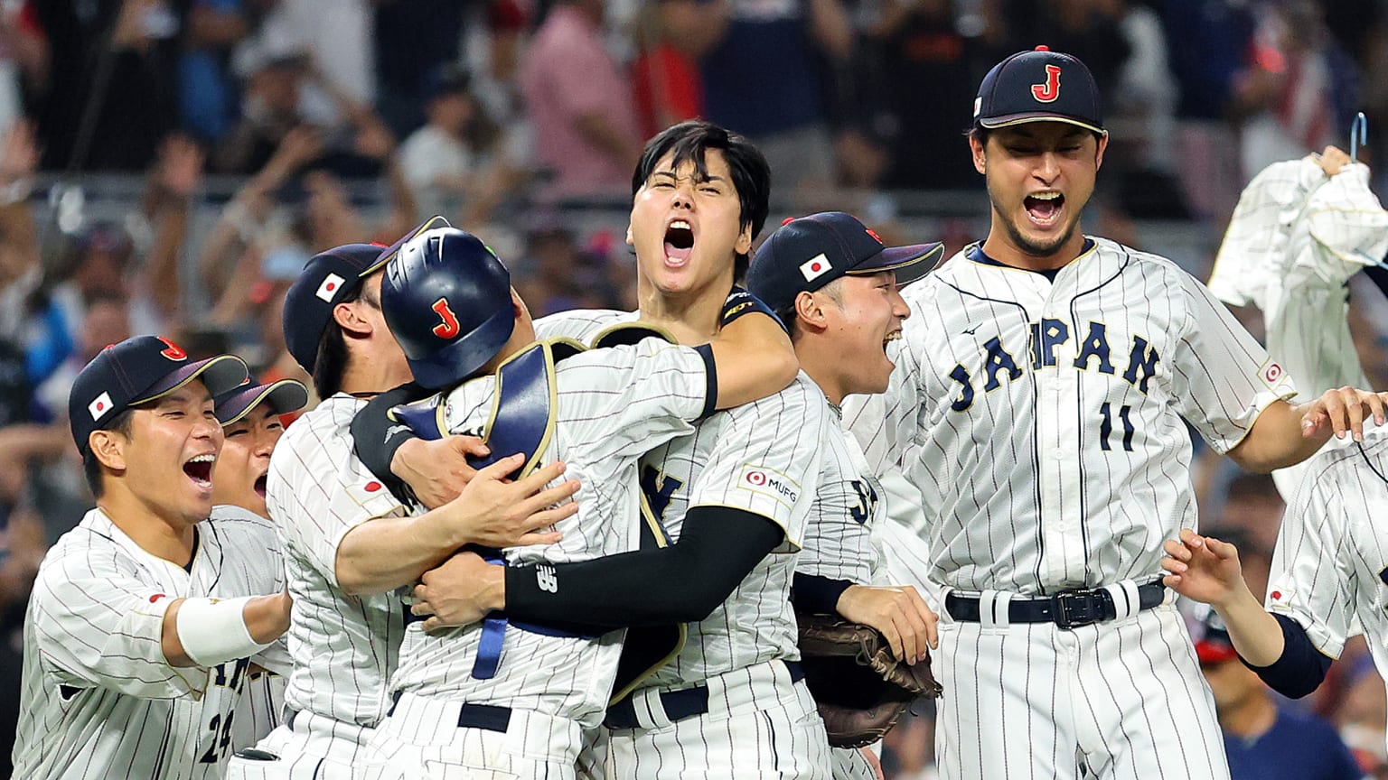 Players from Team Japan celebrate on the field