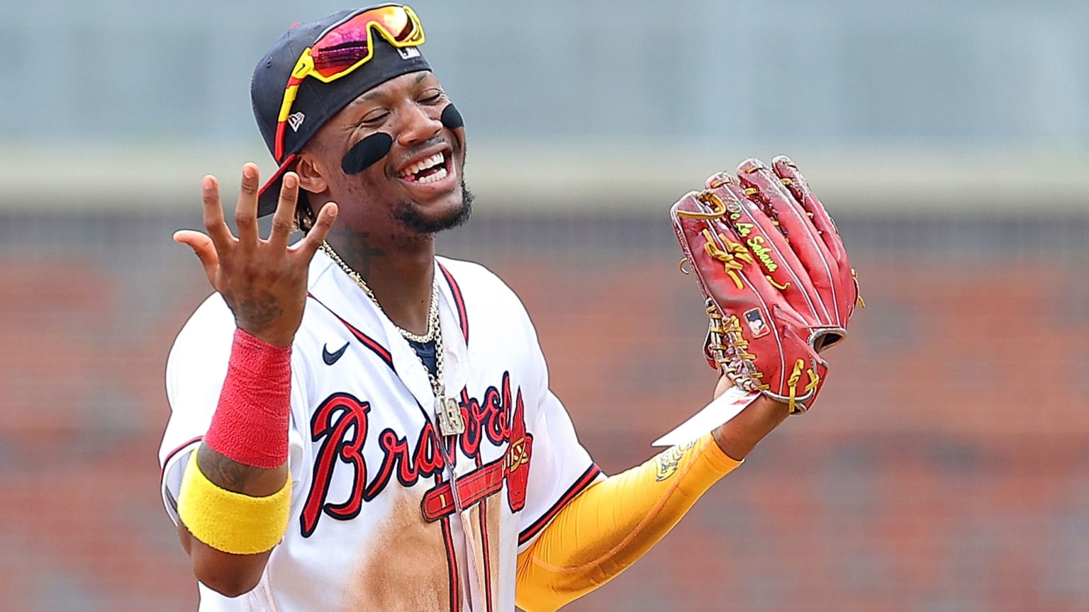 Ronald Acuña Jr. smiles and gestures with his arms