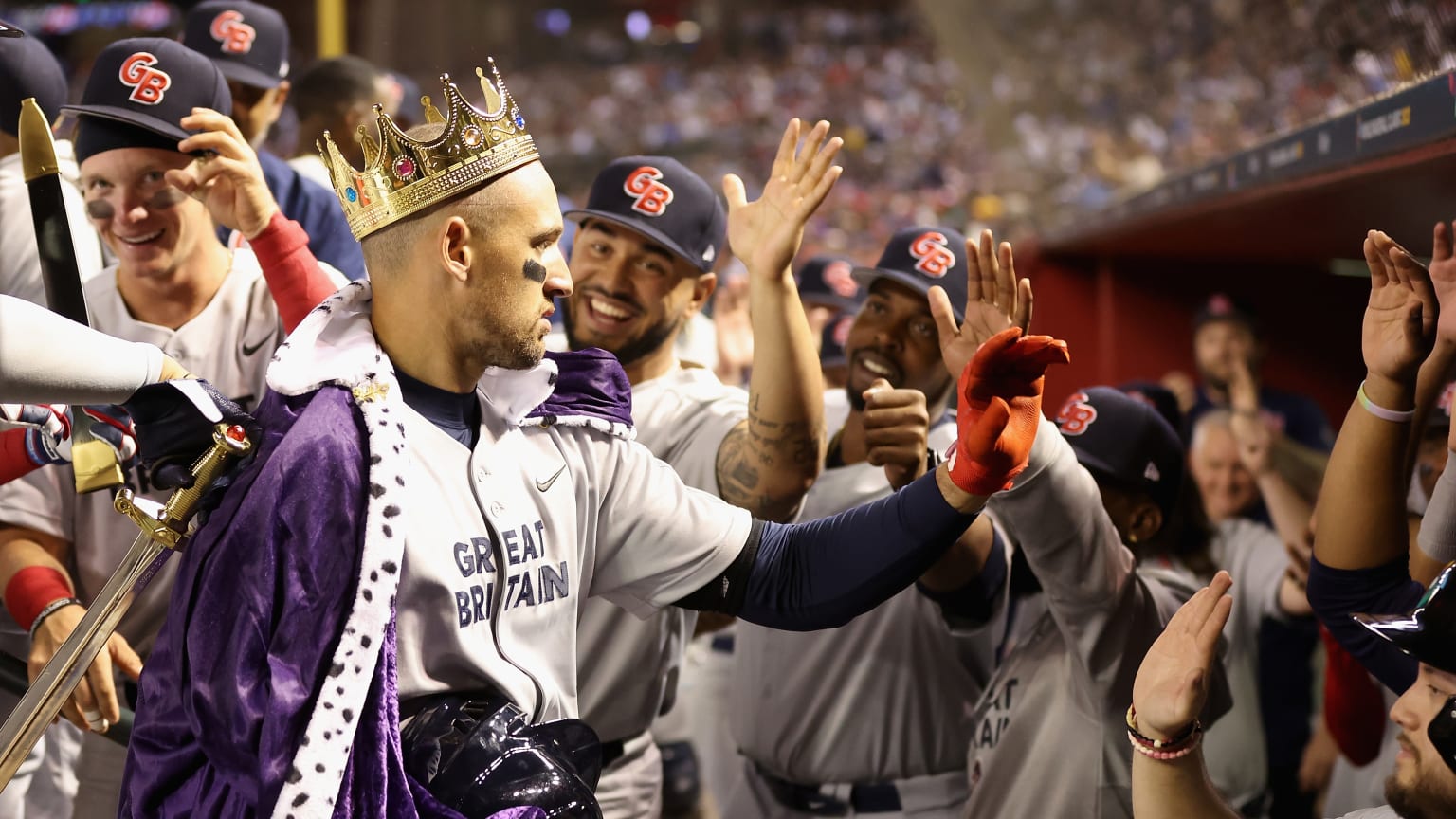 A Great Britain player wears a crown in the dugout