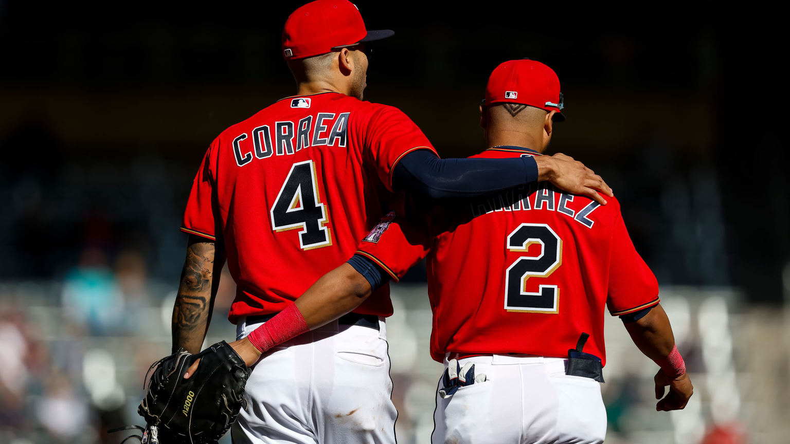 Carlos Correa and Luis Arraez walk away with their arms around each other