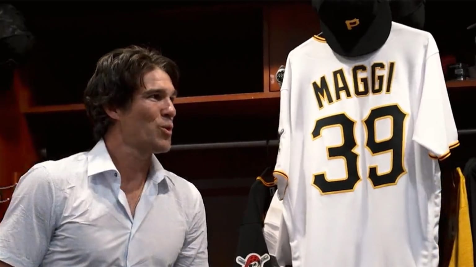 Drew Maggi looks at his Pirates jersey in the clubhouse