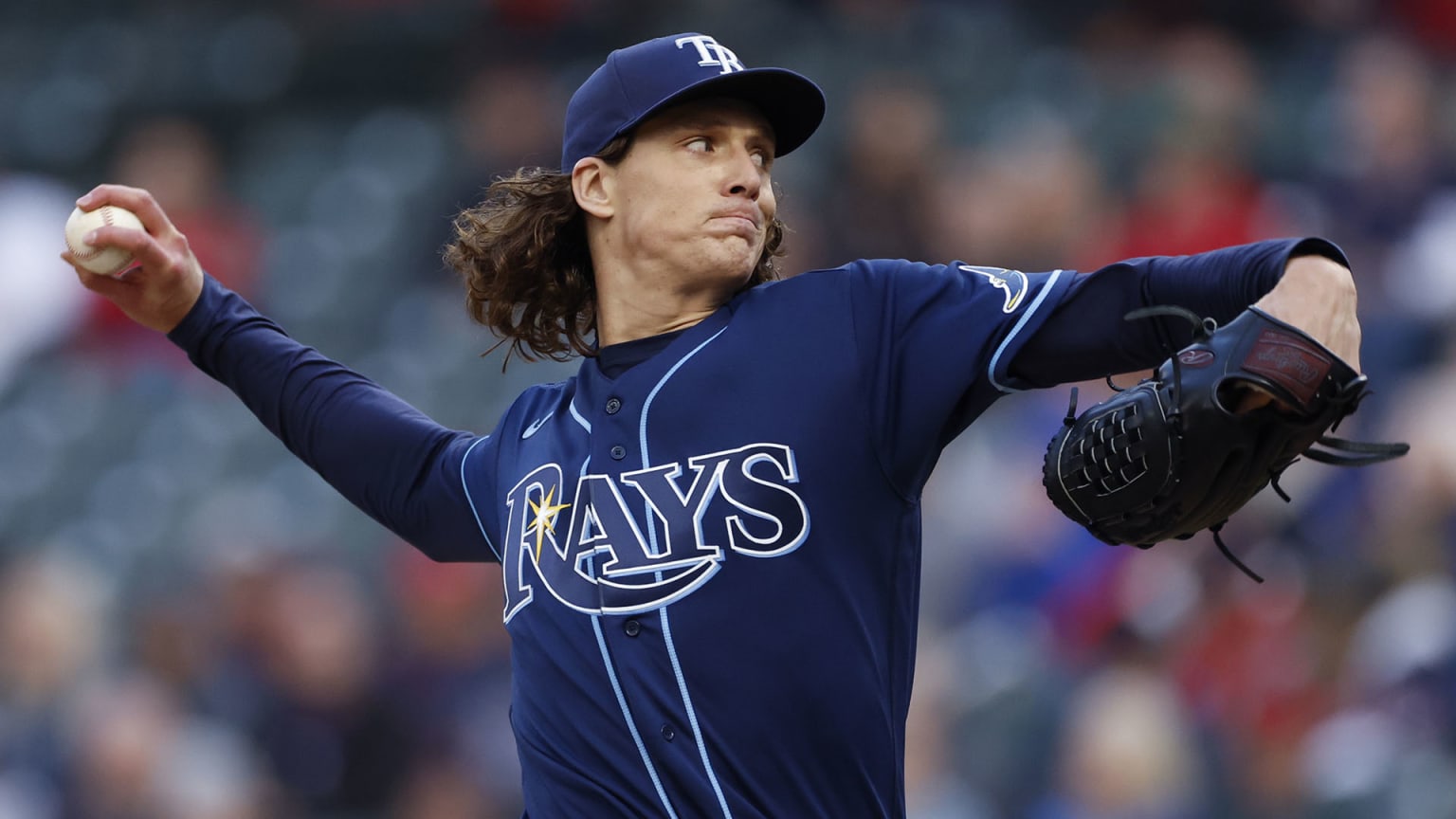 Rays pitcher Tyler Glasnow in mid-pitch, wearing a navy blue cap and navy blue jersey