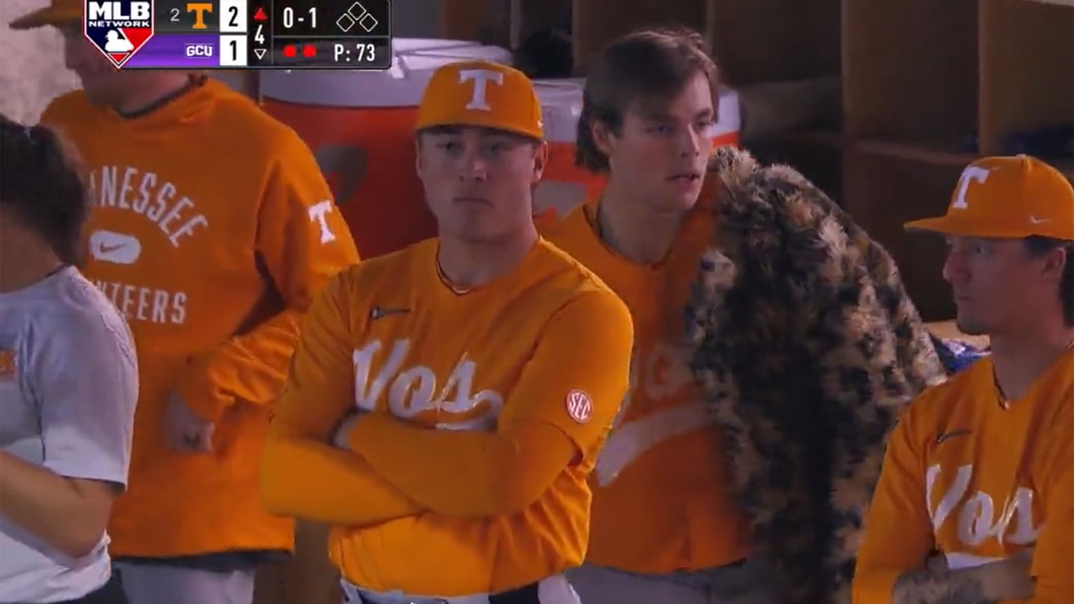 Cal Stark slings a fur coat over his shoulder in the dugout