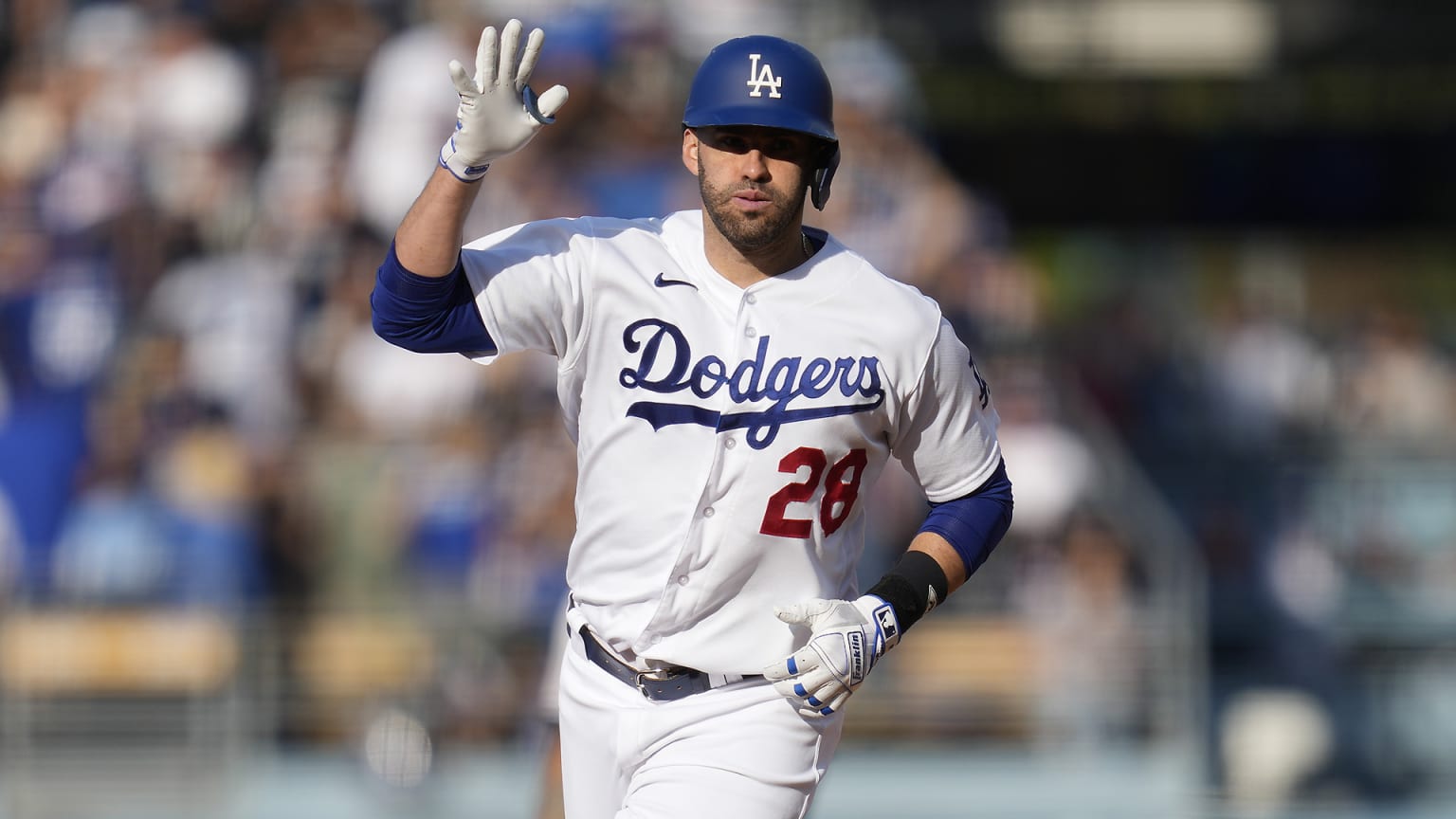 J.D. Martinez holds up his right hand while rounding the bases