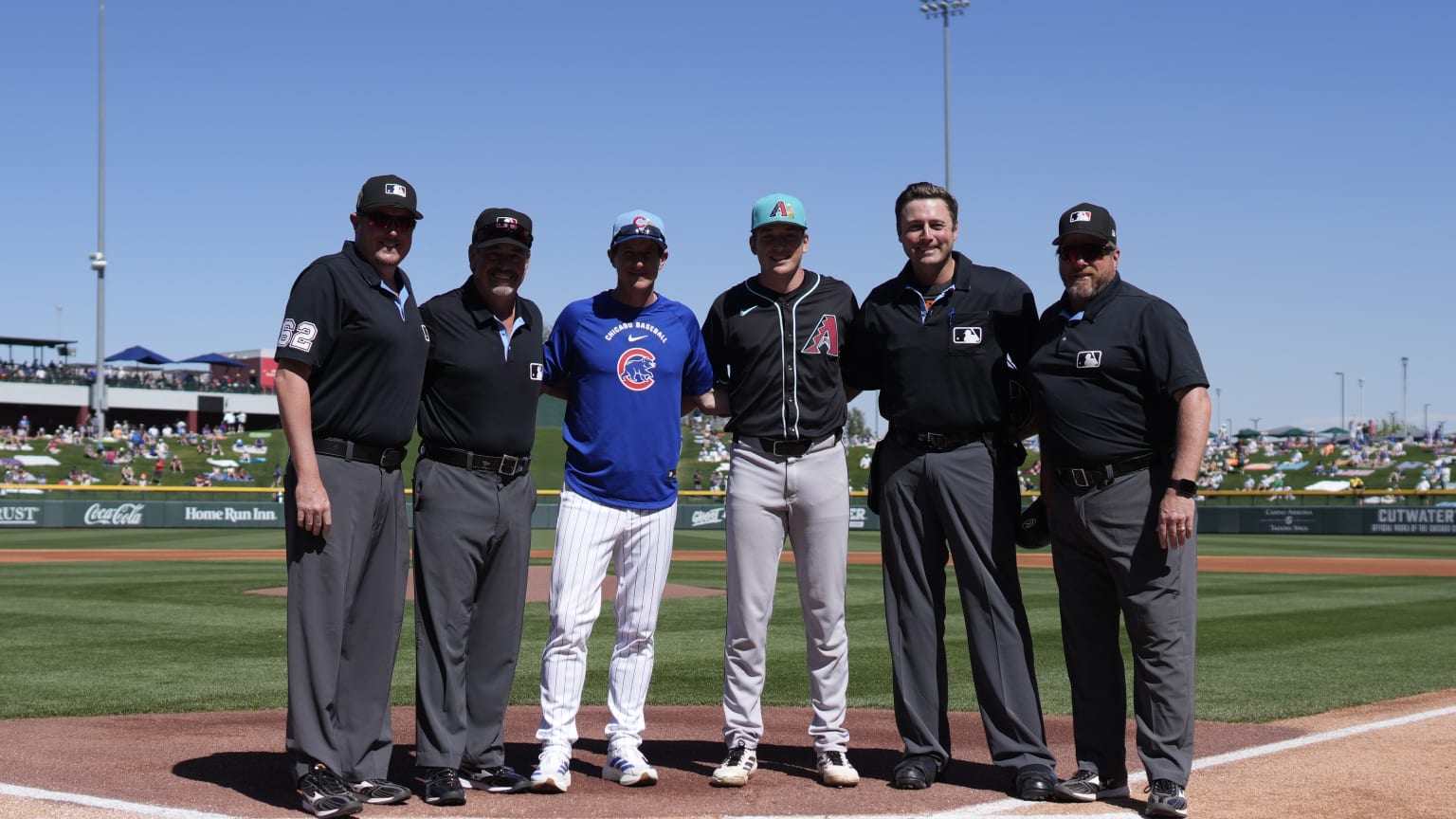 Craig Counsell and his son Brady pose with an umpiring crew