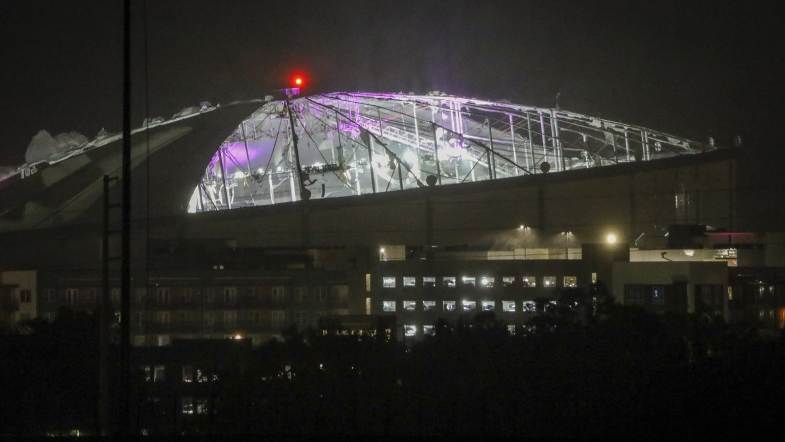 A view of Tropicana Field in the dark with the roof ripped off