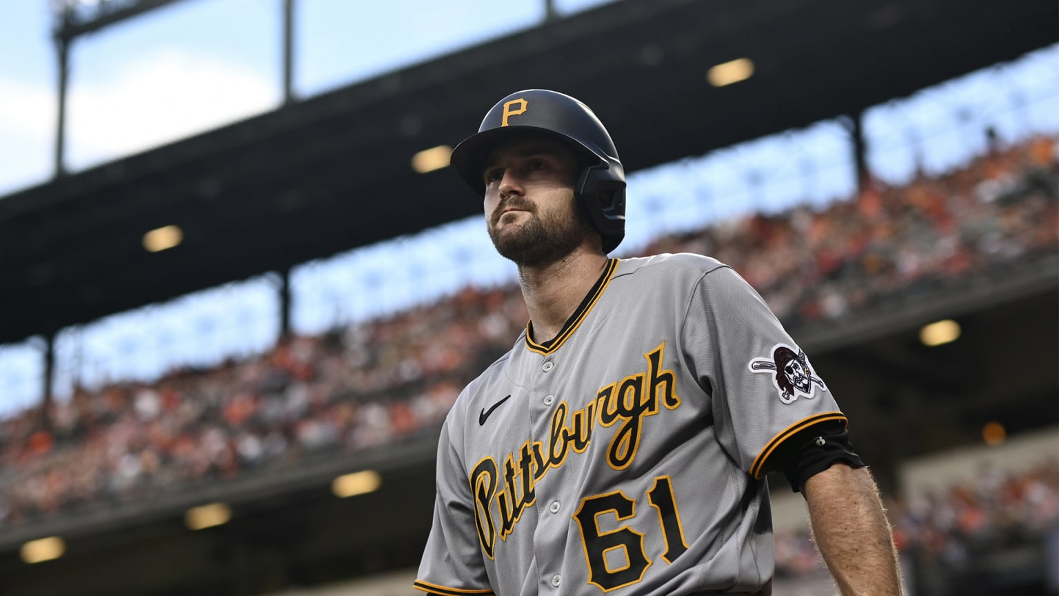 A view from a lower angle of a Pirates player in a road jersey reading ''Pittsburgh,'' the upper deck of a stadium behind him