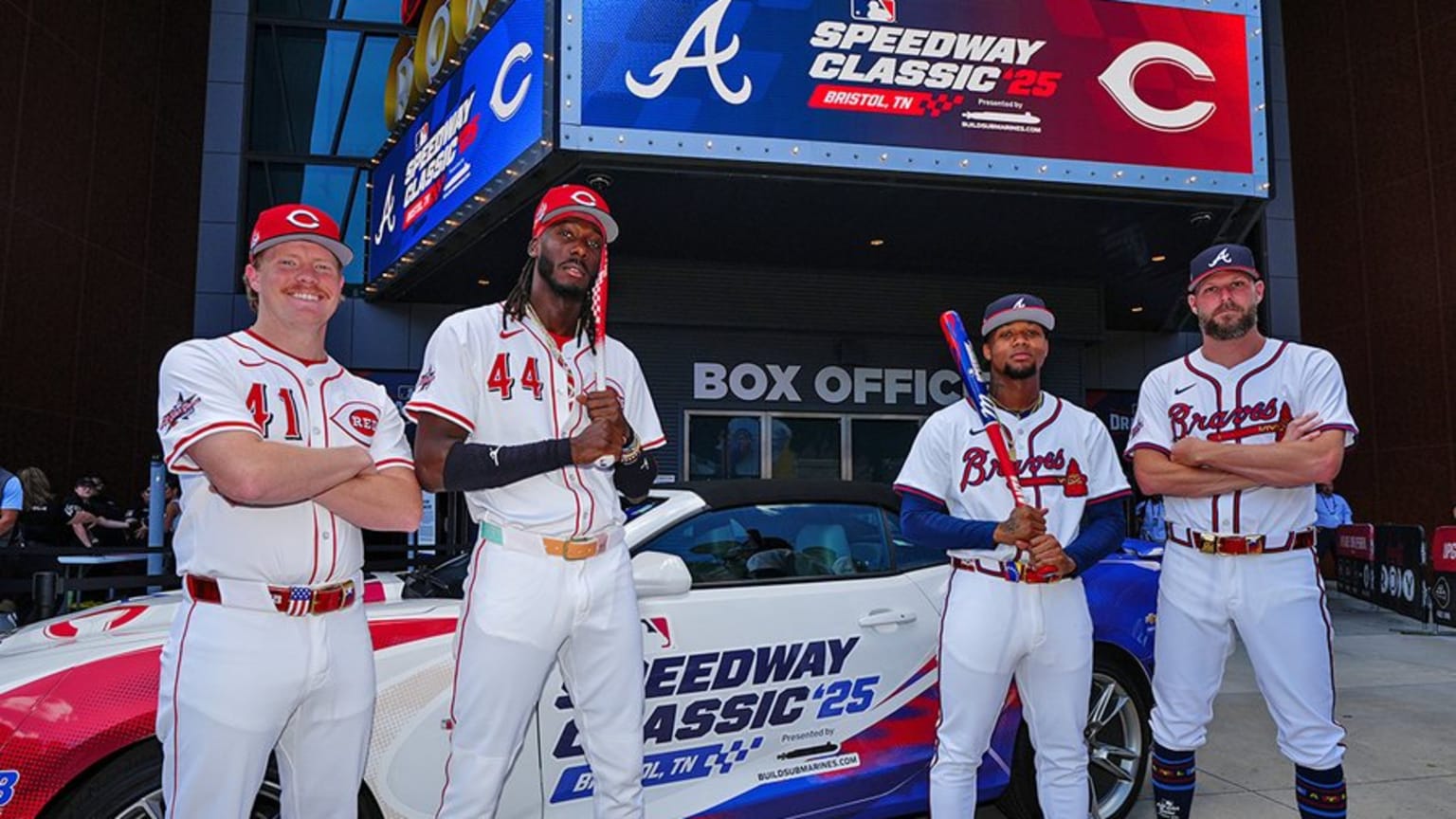 Reds Andrew Abbott and Elly De La Cruz pose with Braves Ronald Acuña Jr. and Chris Sale with a special-edition race car
