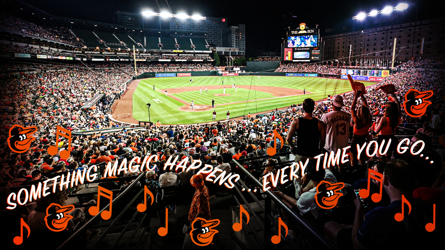 A wide view of Oriole Park at Camden Yards with the field in the distance and fans in the foreground, over which are the lyrics, ''Something magic happens ... every time you go ...'' along with the Orioles bird logo and orange musical notes