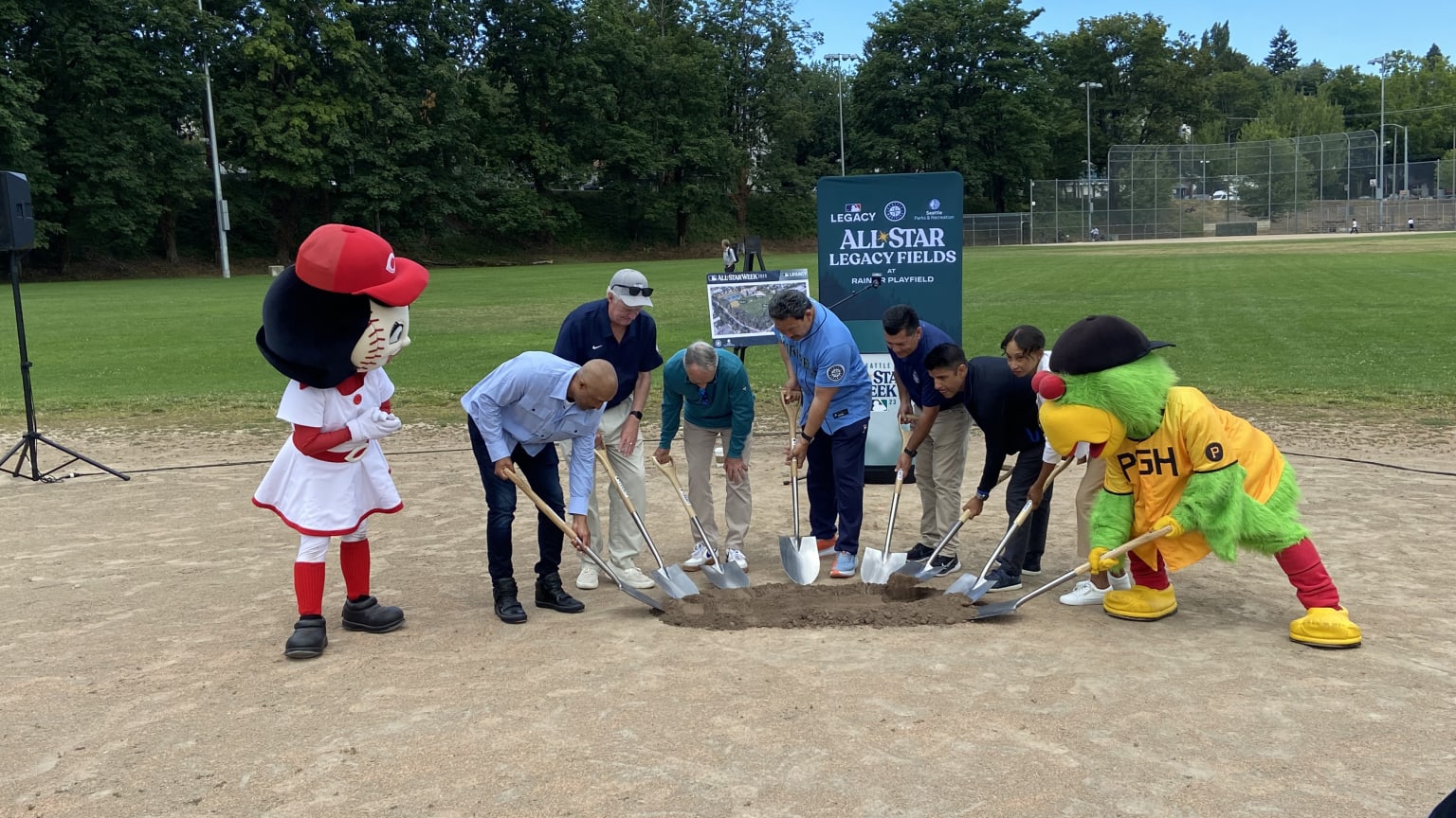 Mascots for the Reds and Pirates help dig into the dirt for a groundbreaking ceremony