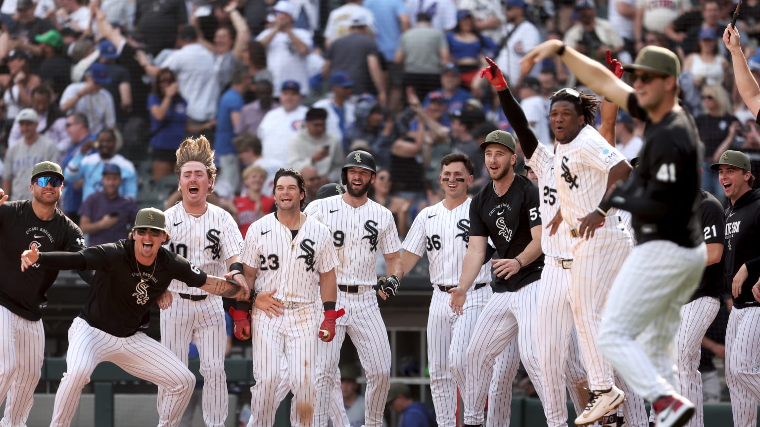 The White Sox celebrate a walk-off win over the Cubs at home plate