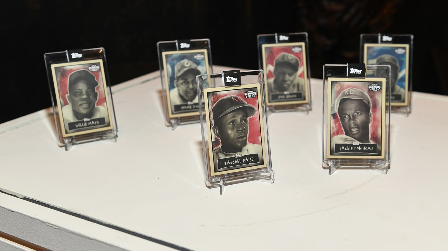 Trading cards of Willie Mays, Satchel Paige, Jackie Robinson, Josh Gibson, Larry Doby and Monte Irvin