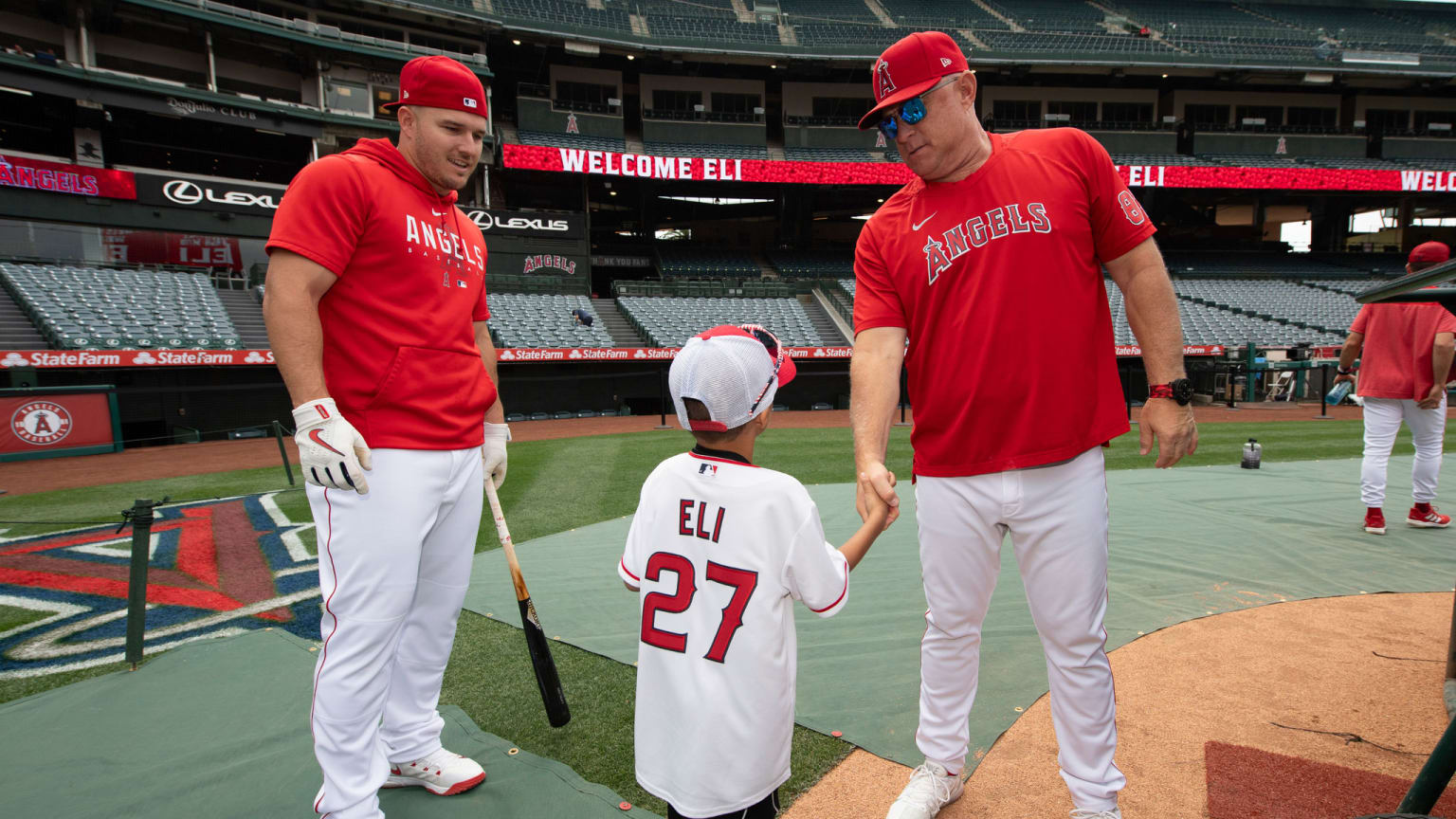 Mike Trout shows a child around the field