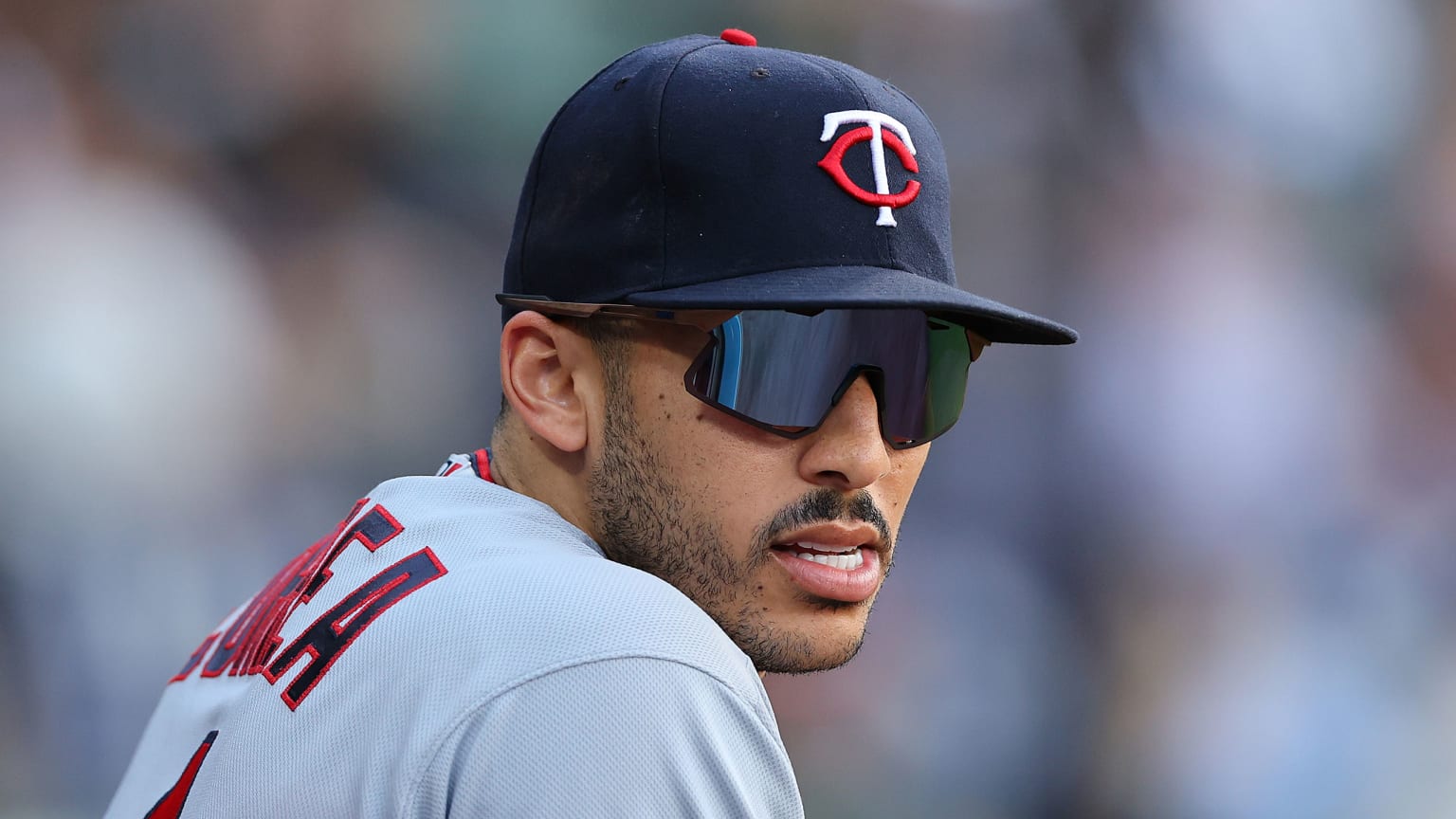 Carlos Correa, in sunglasses, looks toward the camera