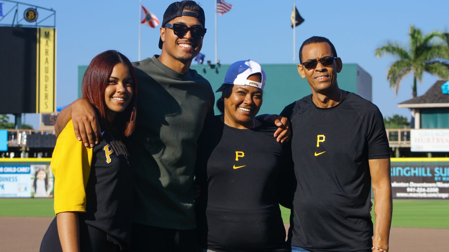 Pirates pitcher Johan Oviedo poses for a photo with parents and sister