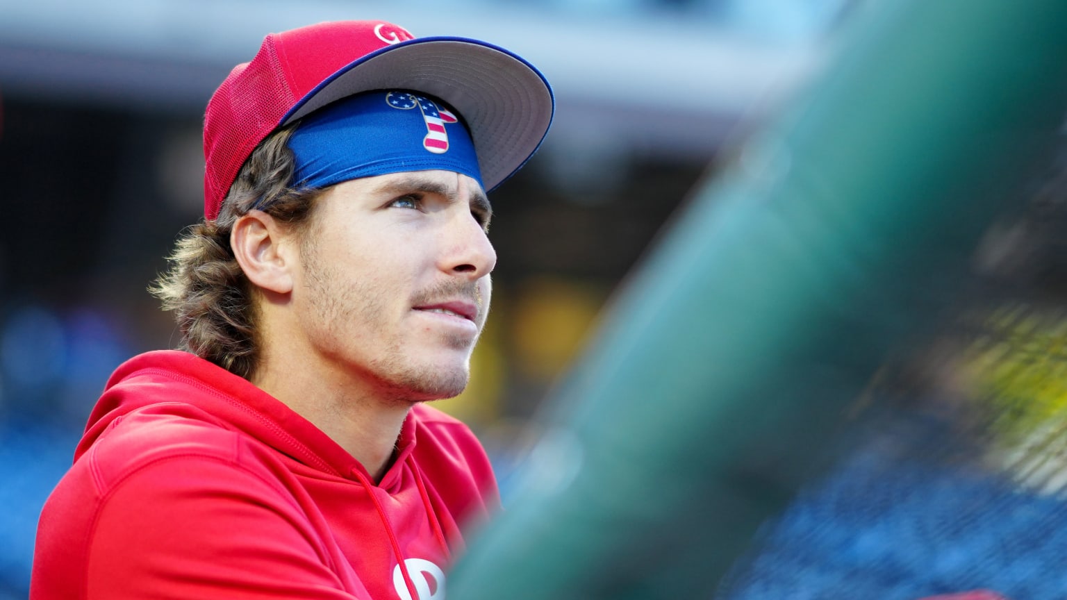 Bryson Stott watches from behind the batting cage