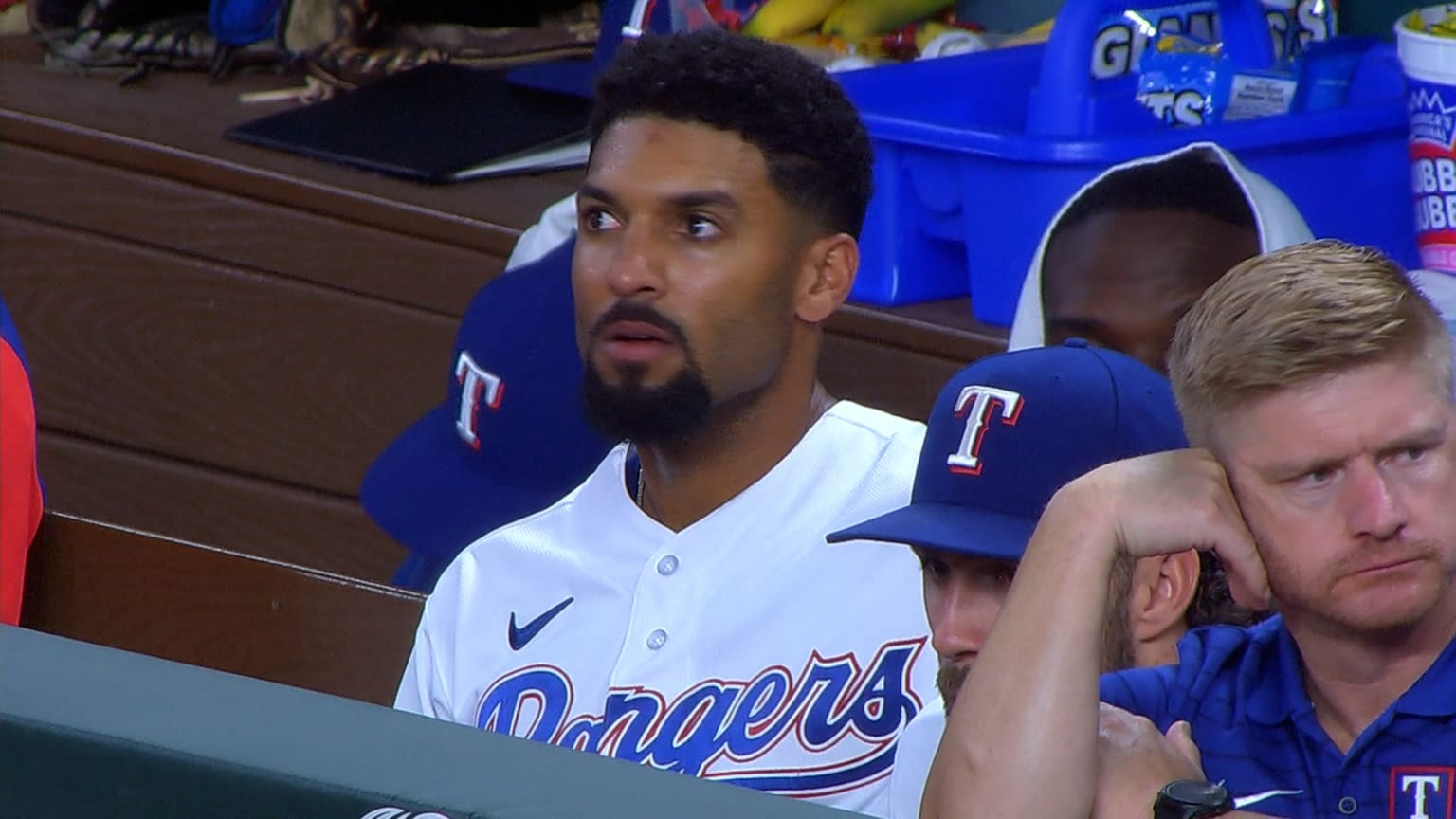 Marcus Semien sits on the dugout bench just before realizing he has to bat