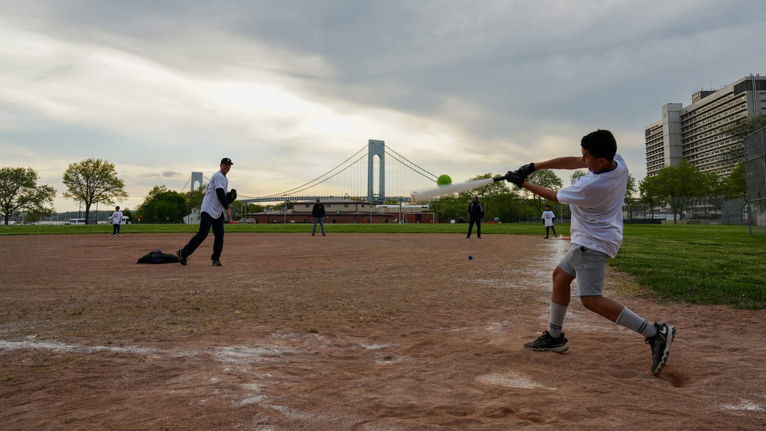 A young player swings the bat at a Play Ball event