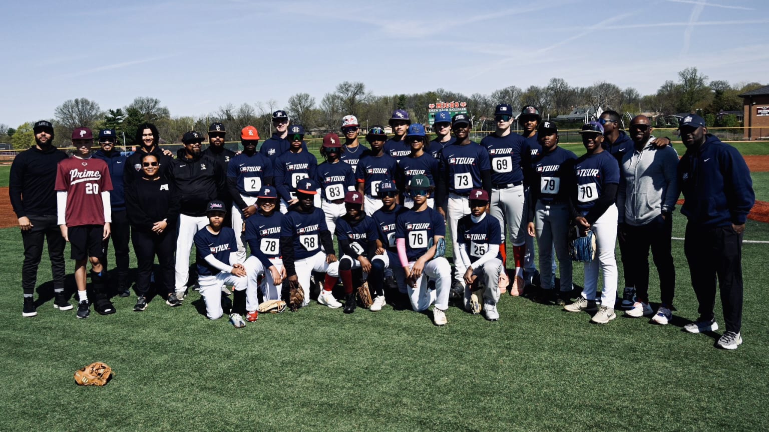 A group of players pose for a photograph on a grass field