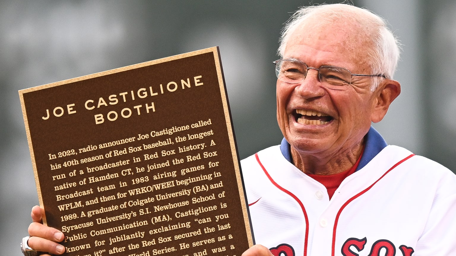 Joe Castiglione poses with a plaque