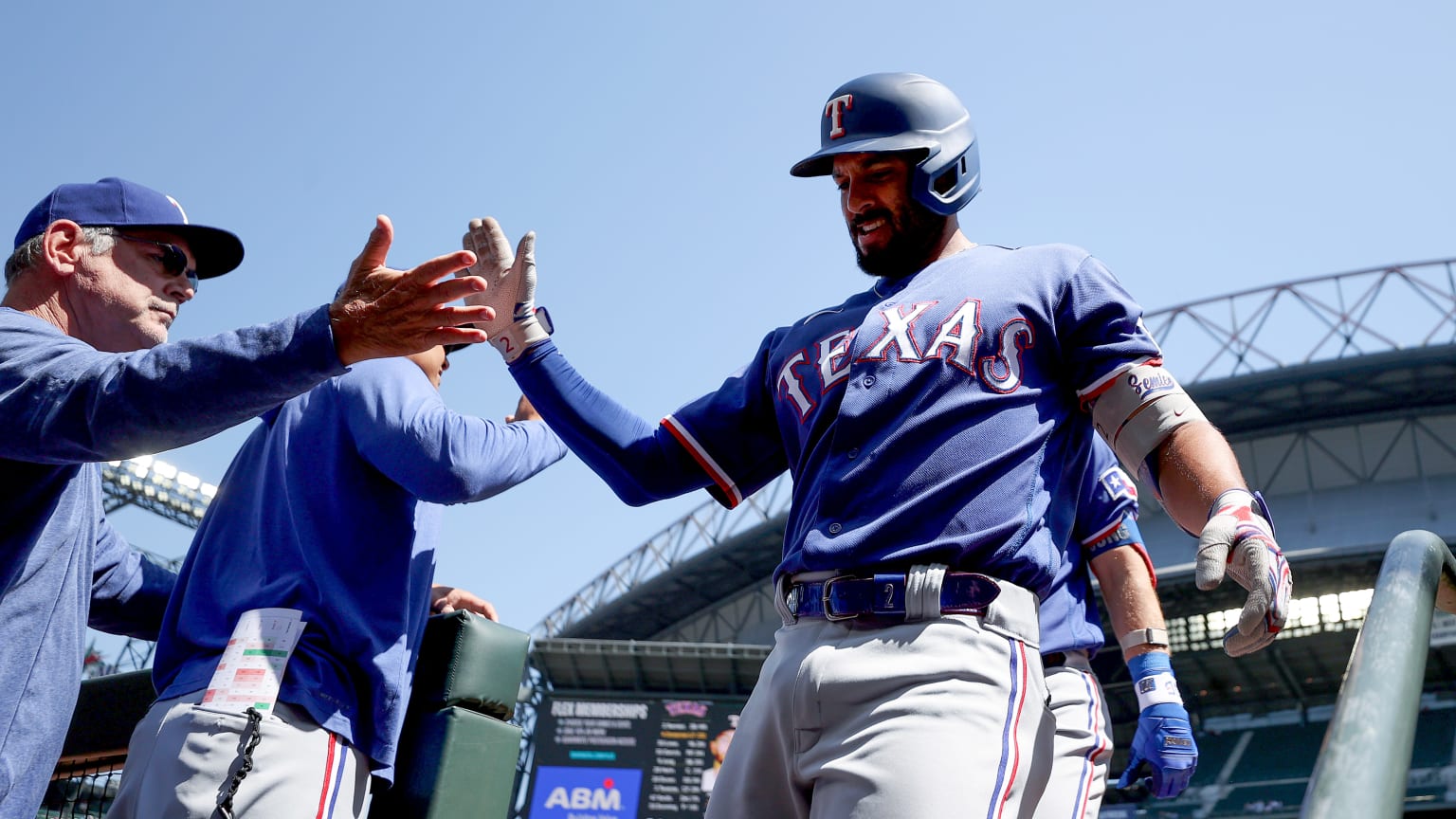 Bruce Bochy high-fives Marcus Semien as he reaches the dugout