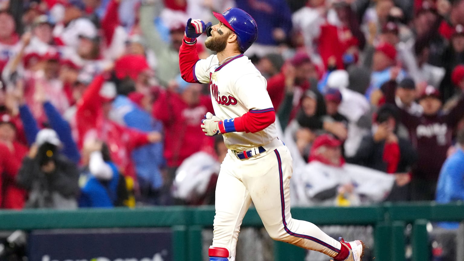 Bryce Harper raises his arm and looks to the sky while rounding the bases after a home run