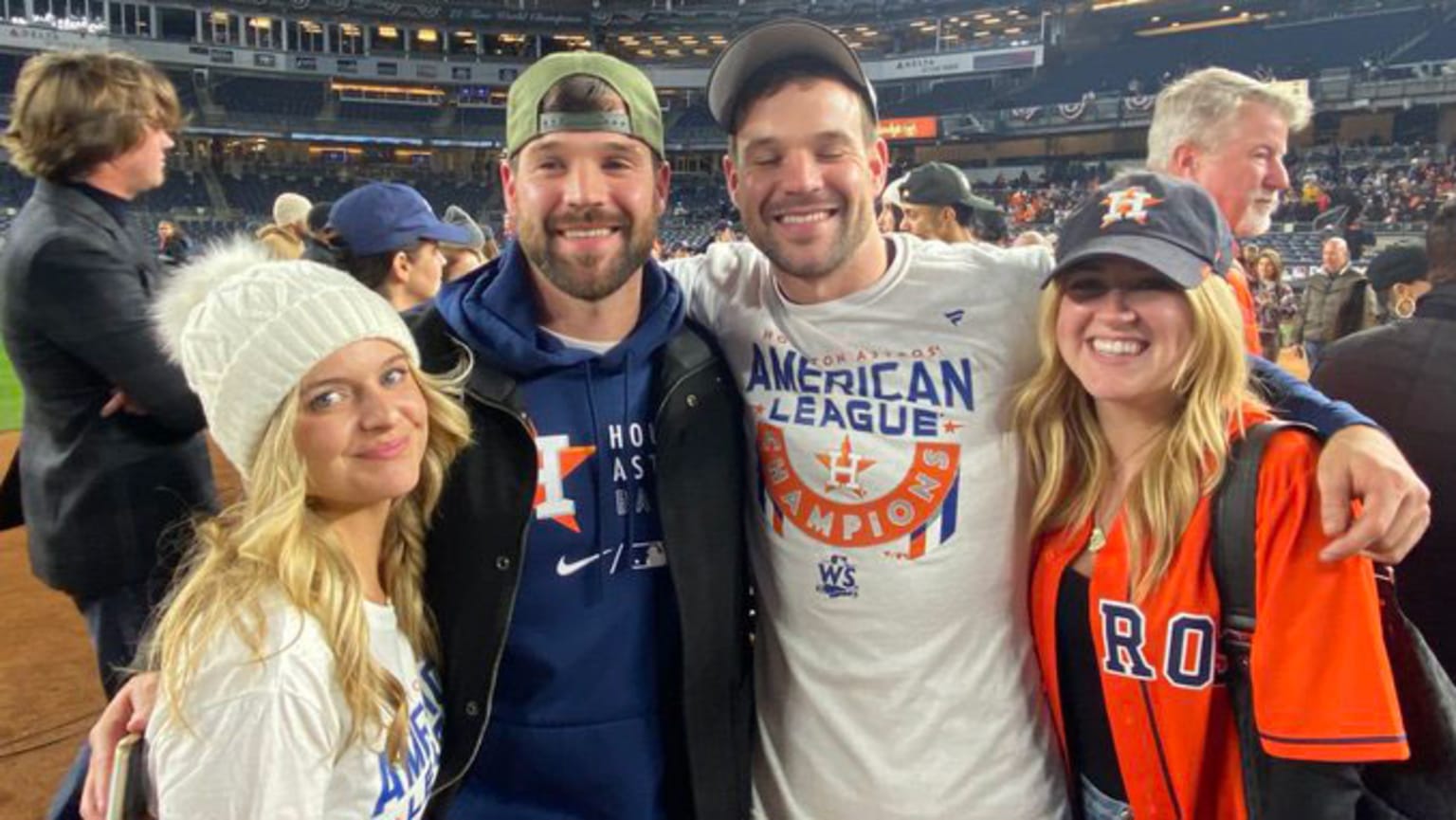 Twin brothers Chas and Jason McCormick pose for a photo on the field after the Astros' ALCS-clinching victory.