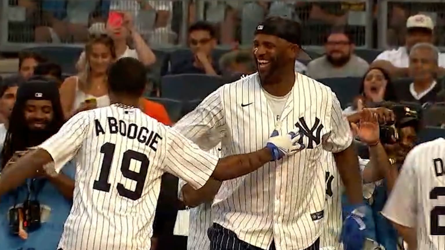 CC Sabathia laughs with participants in his softball game