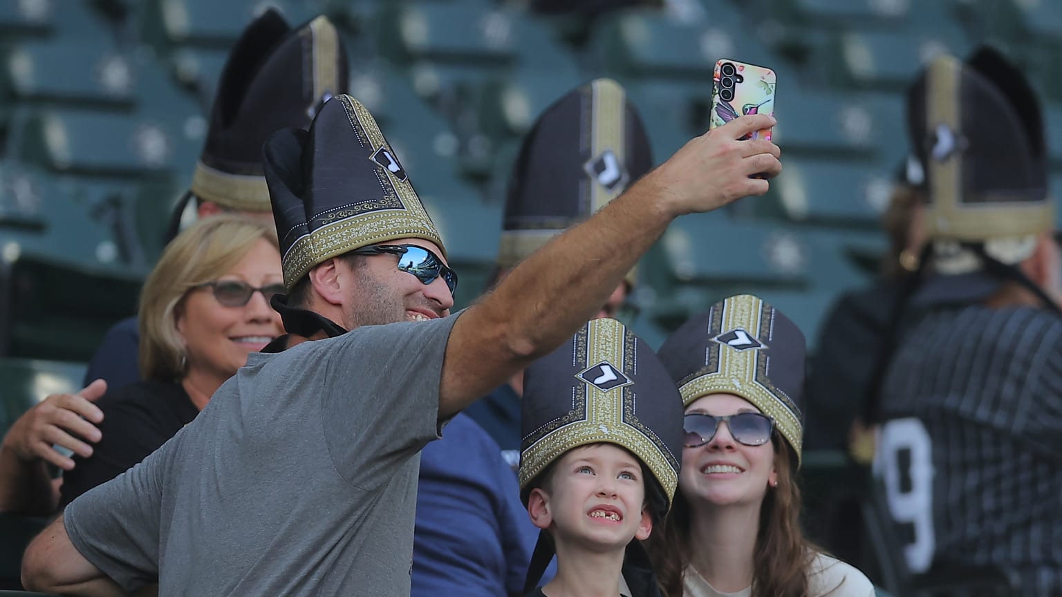 Chicago White Sox fans wearing black and gold Pope Hats during Pope Hat Night at Rate Field