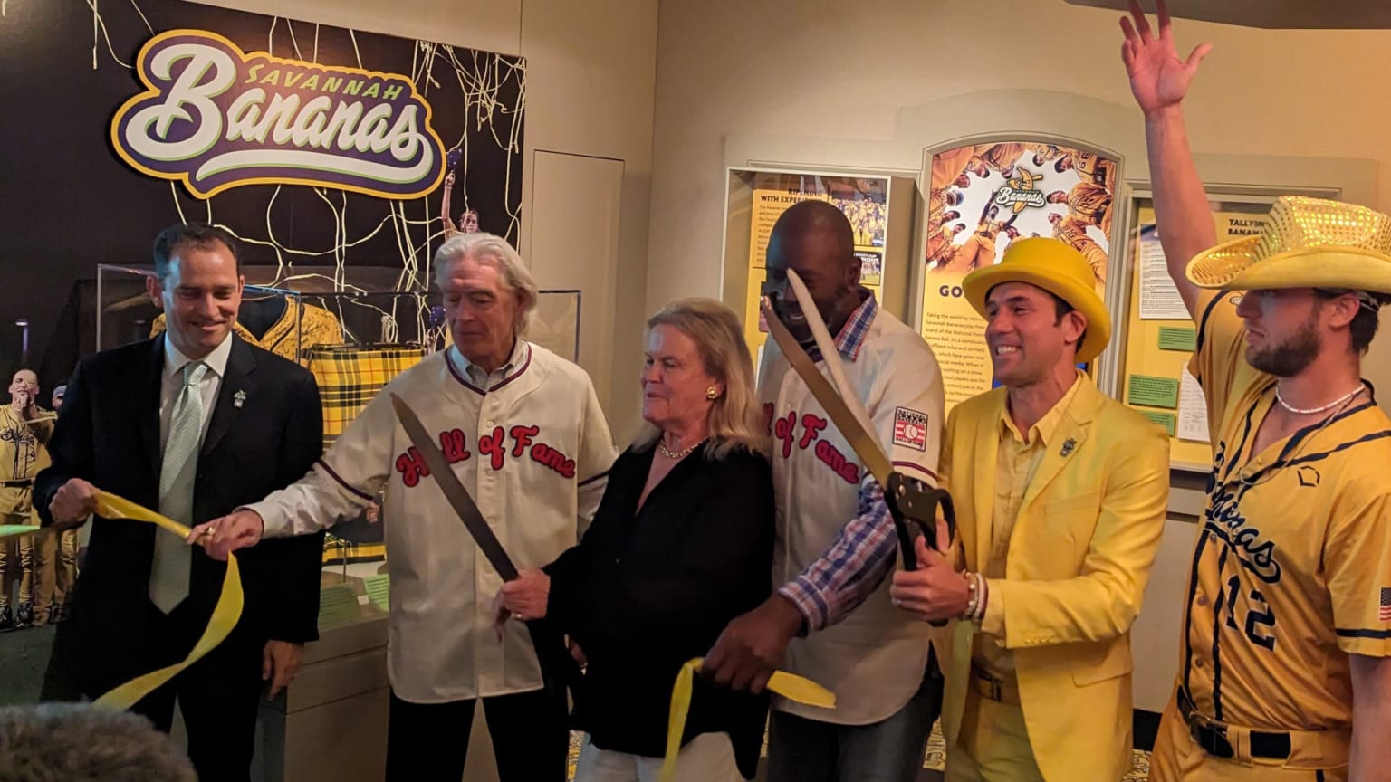 Hall of Famers and staff cut the ribbon on a new exhibit with the Savannah Bananas