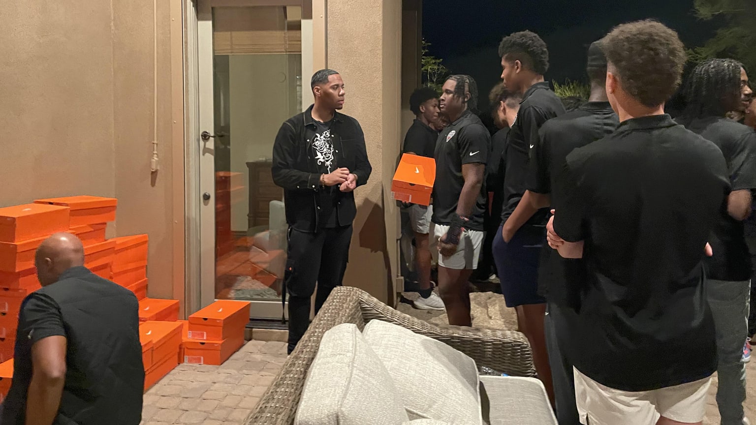 Hunter Greene talks with a group of young players